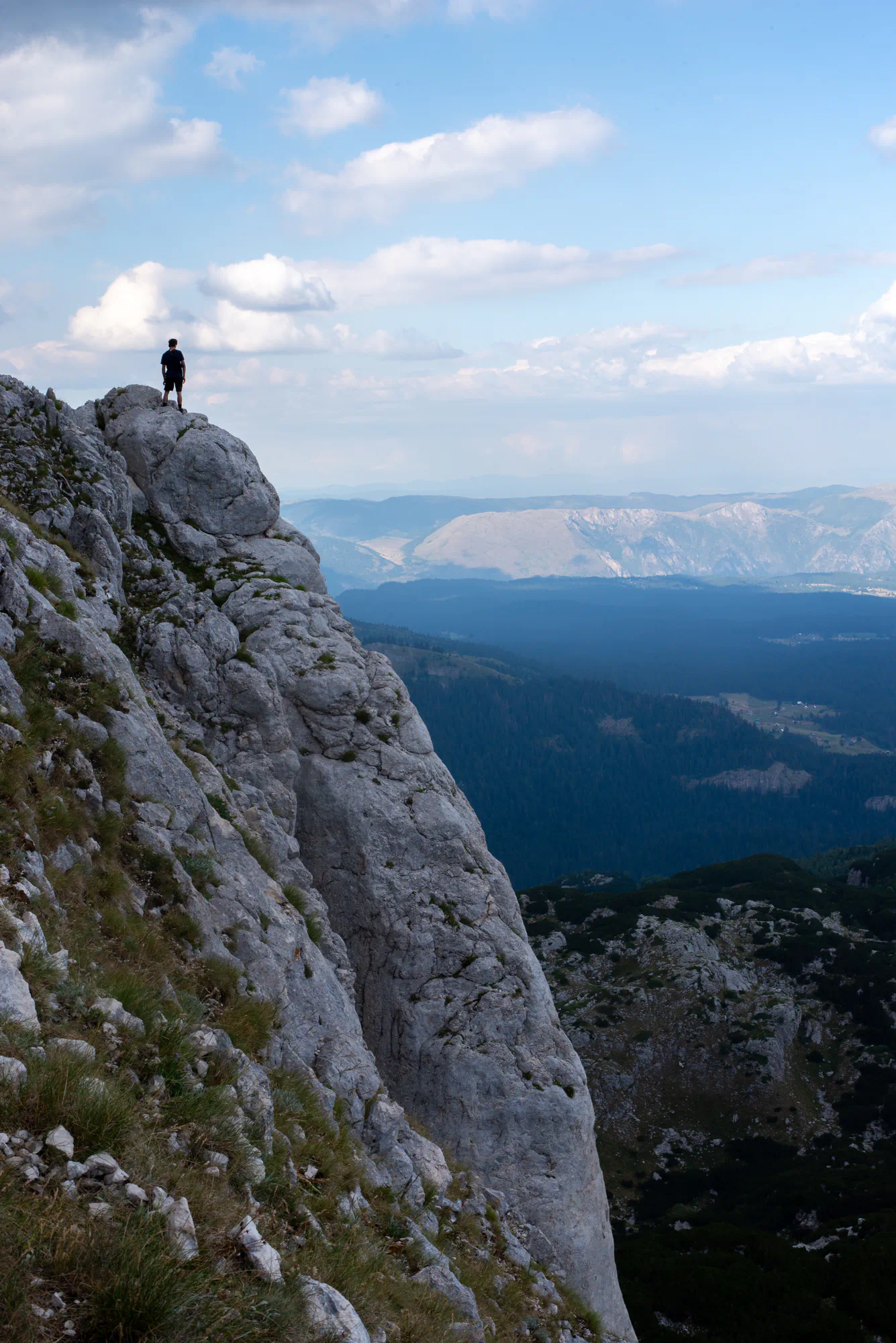 person on cliff looking at view
